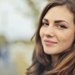 Close-up portrait of a smiling young woman outdoors in Budapest.